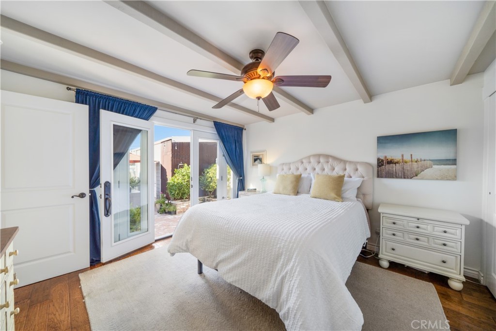 53 Saratoga Newport Beach, CA 92660 - Photo 14 of 31 a bedroom with a bed and a chandelier