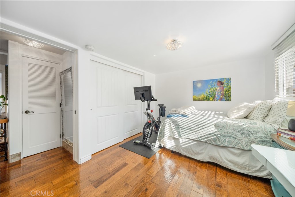 53 Saratoga Newport Beach, CA 92660 - Photo 18 of 31 a bedroom with a bed and a wooden floor