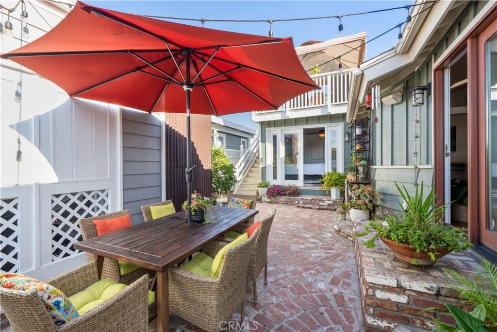 53 Saratoga Newport Beach, CA 92660 - Photo 21 of 31 a view of a patio with a table and chairs under an umbrella