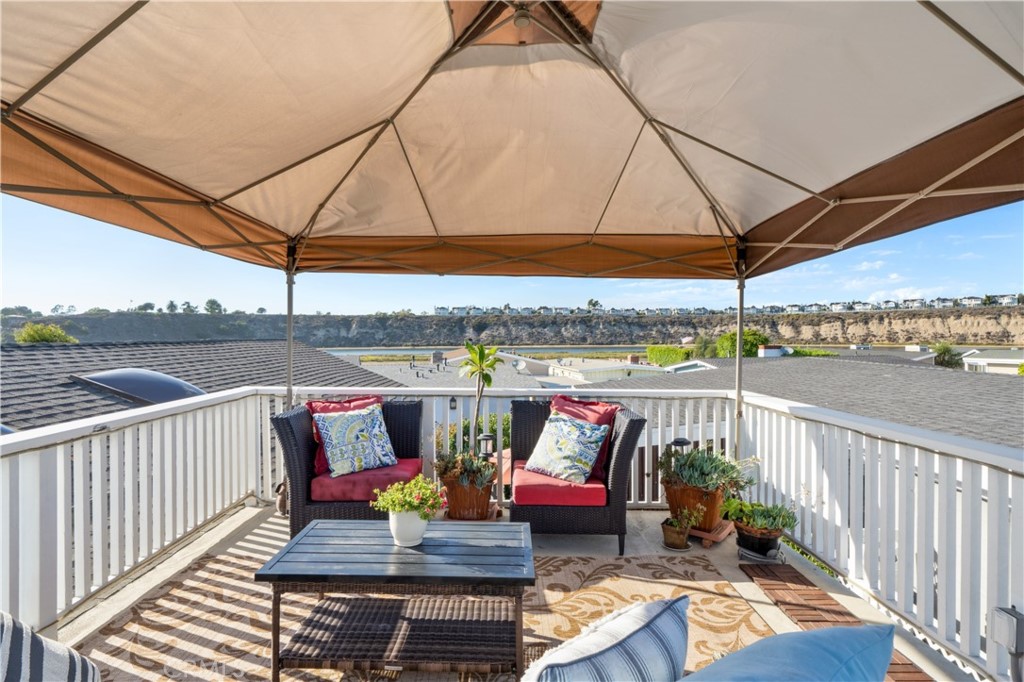 53 Saratoga Newport Beach, CA 92660 - Photo 25 of 31 a view of a balcony with wooden floor and outdoor seating