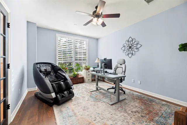 a view of a workspace with furniture and a window