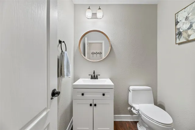 a bathroom with a sink a toilet and a mirror