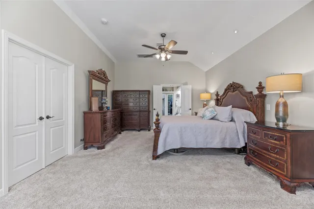 a spacious bedroom with a bed and a chandelier