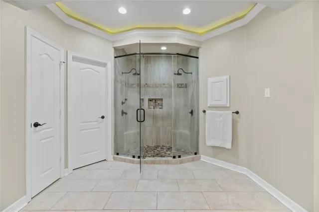 a bathroom with a shower and a glass door