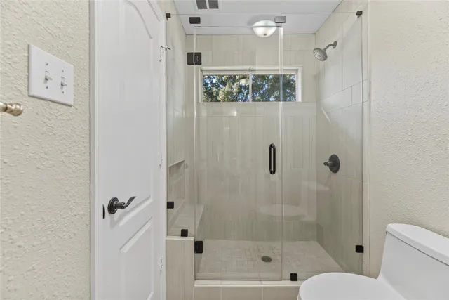 a bathroom with a glass shower door
