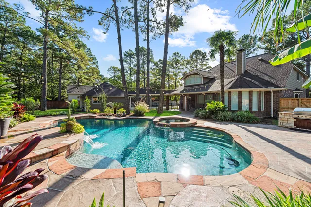 a view of a patio with a dining table and chairs with wooden fence