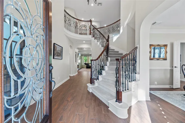 a view of entryway and hall with wooden floor