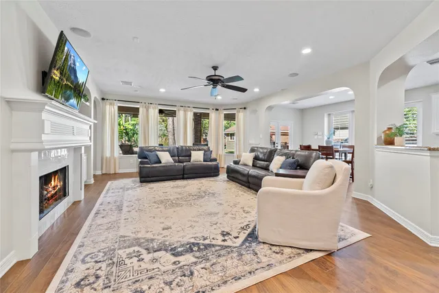 a living room with furniture a fireplace and a flat screen tv