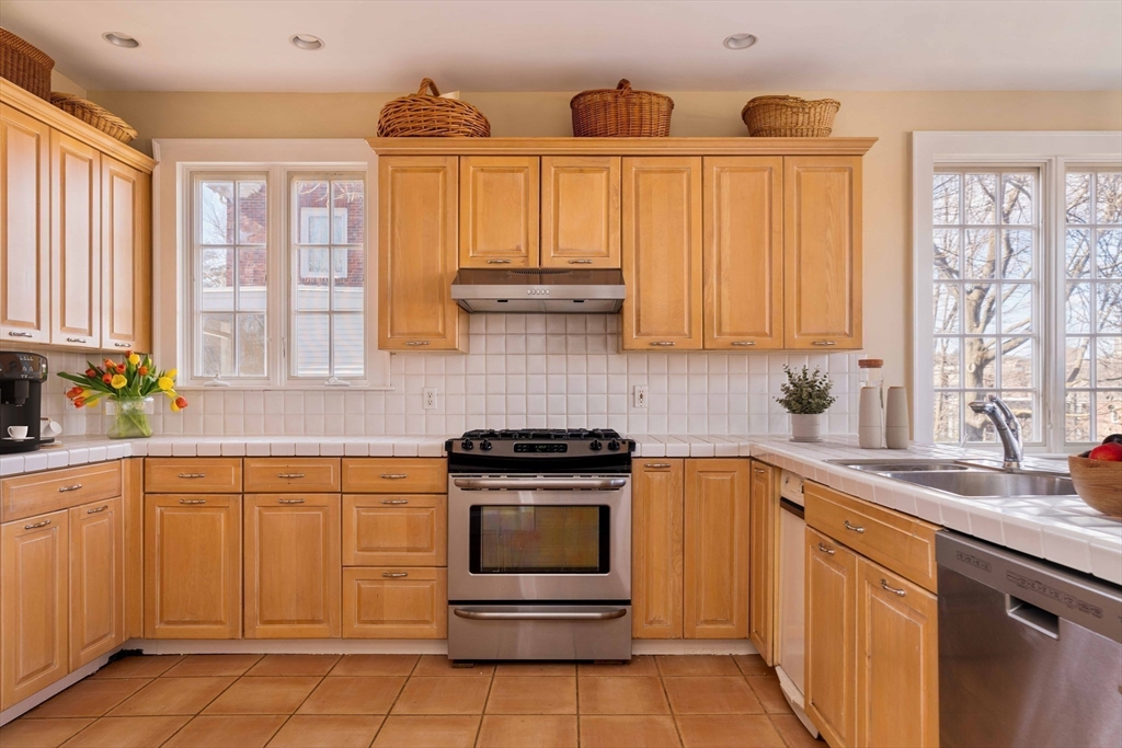 289 Clinton Road Brookline, MA 02445 - Photo 13 of 24 a kitchen with a sink stove and cabinets
