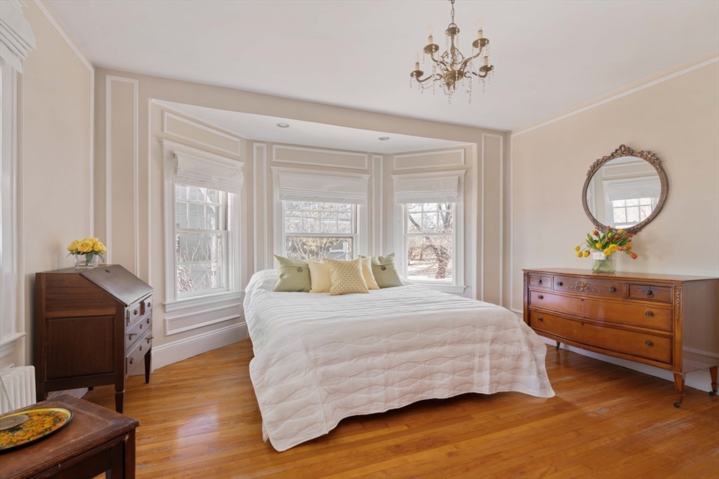 289 Clinton Road Brookline, MA 02445 - Photo 15 of 24 a bedroom with a bed and wooden floor