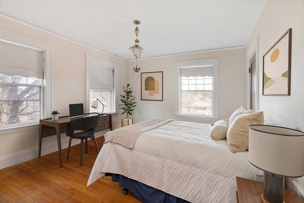 289 Clinton Road Brookline, MA 02445 - Photo 16 of 24 a bedroom with a bed and wooden floor