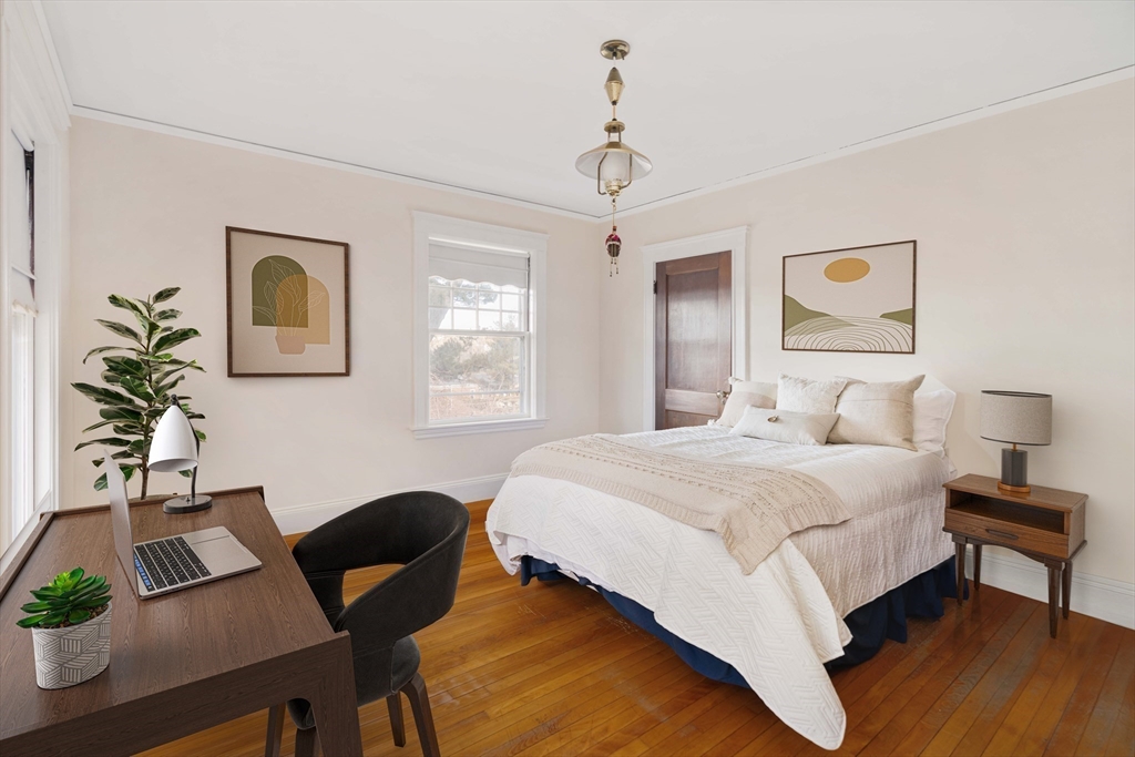 289 Clinton Road Brookline, MA 02445 - Photo 17 of 24 a bedroom with a bed and a table