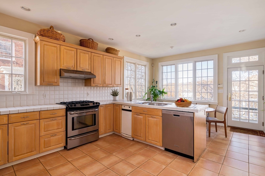 289 Clinton Road Brookline, MA 02445 - Photo 2 of 24 a kitchen with a sink stove and cabinets