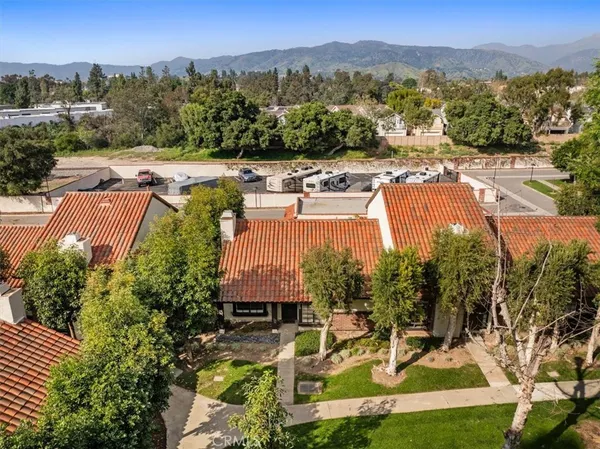 an aerial view of a house with a garden and lake view