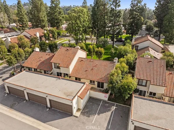 an aerial view of a house with garden space and street view