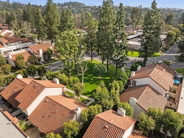 an aerial view of multiple houses with yard