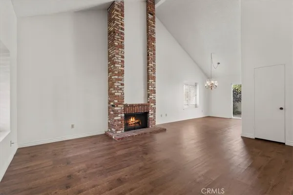 a view of a livingroom with wooden floor and window