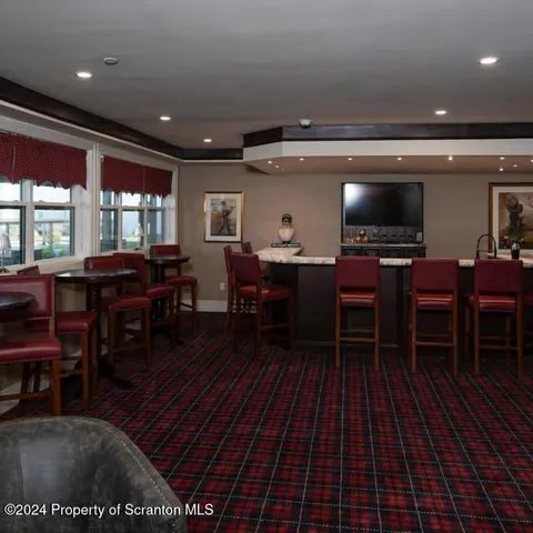 a living room with furniture a dining table and a piano