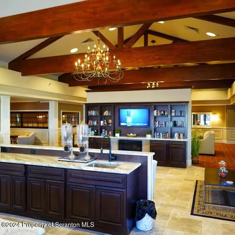 a kitchen with a counter space a sink and cabinets