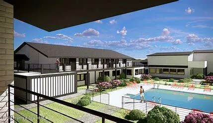 a view of a house with pool and chairs