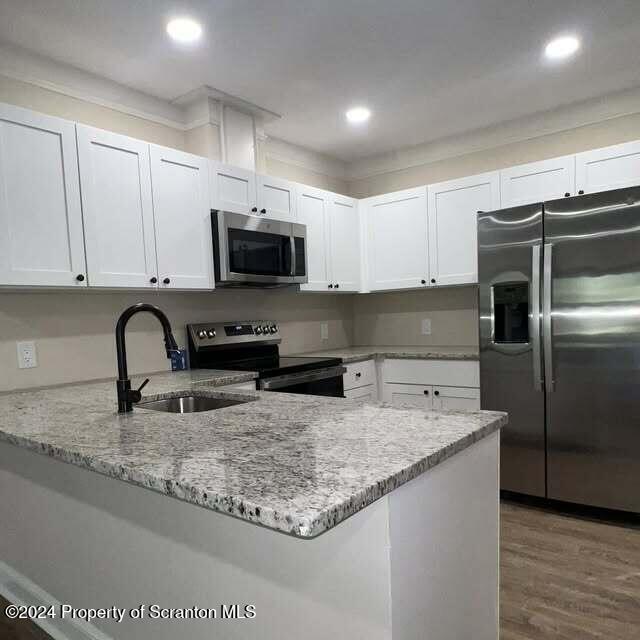 201 Resort Lane Tunkhannock, PA 18657 - Photo 19 of 32 a kitchen with granite countertop a sink and a stove top oven with wooden floor