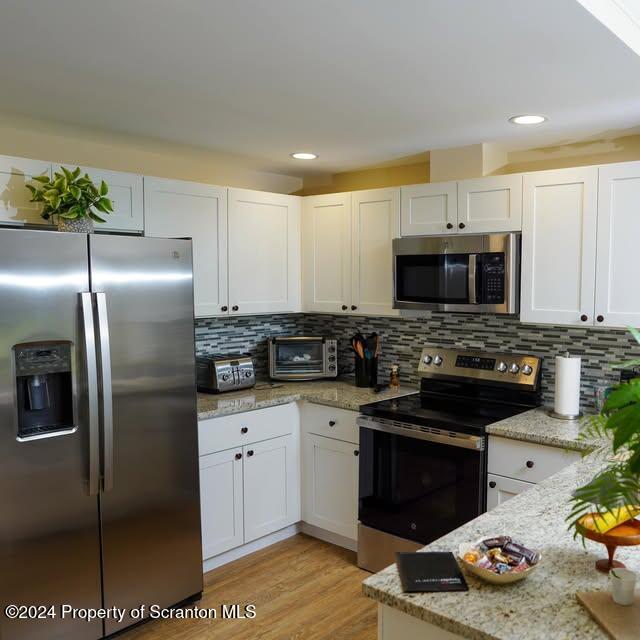 201 Resort Lane Tunkhannock, PA 18657 - Photo 31 of 32 a kitchen with stainless steel appliances granite countertop a refrigerator a stove and a sink