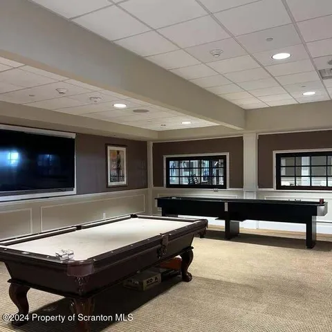 a living room with furniture pool and flat screen tv