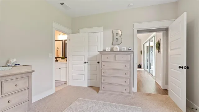 walk in closet with white cabinet