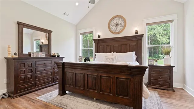 a room with a bed a mirror and a window