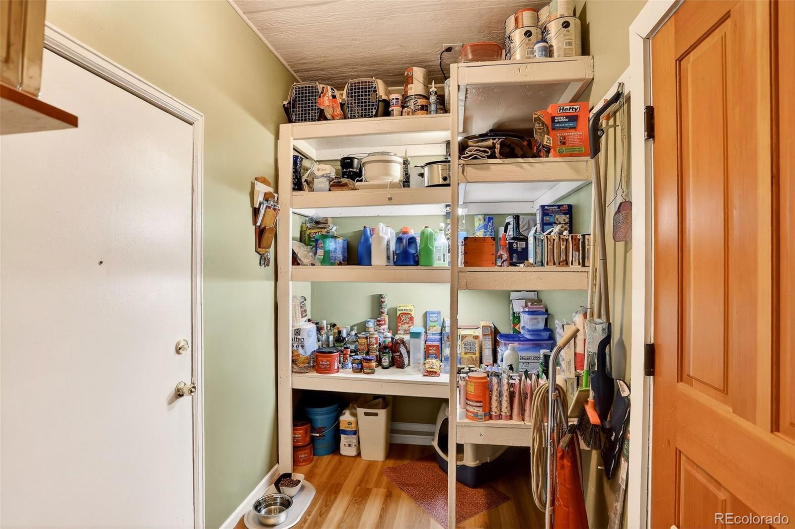 1503 South Mobile Street Aurora, CO 80017 - Photo 18 of 19 a view of walk in closet with clothes and shoes