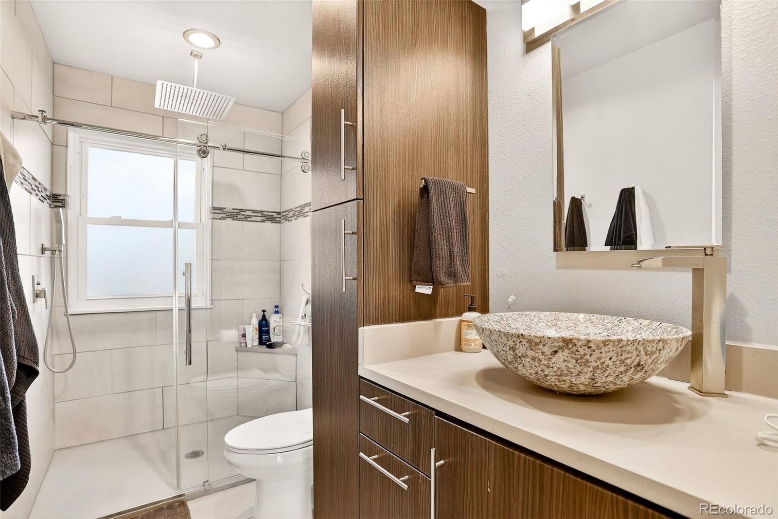 1503 South Mobile Street Aurora, CO 80017 - Photo 9 of 19 a bathroom with a granite countertop sink a toilet and shower