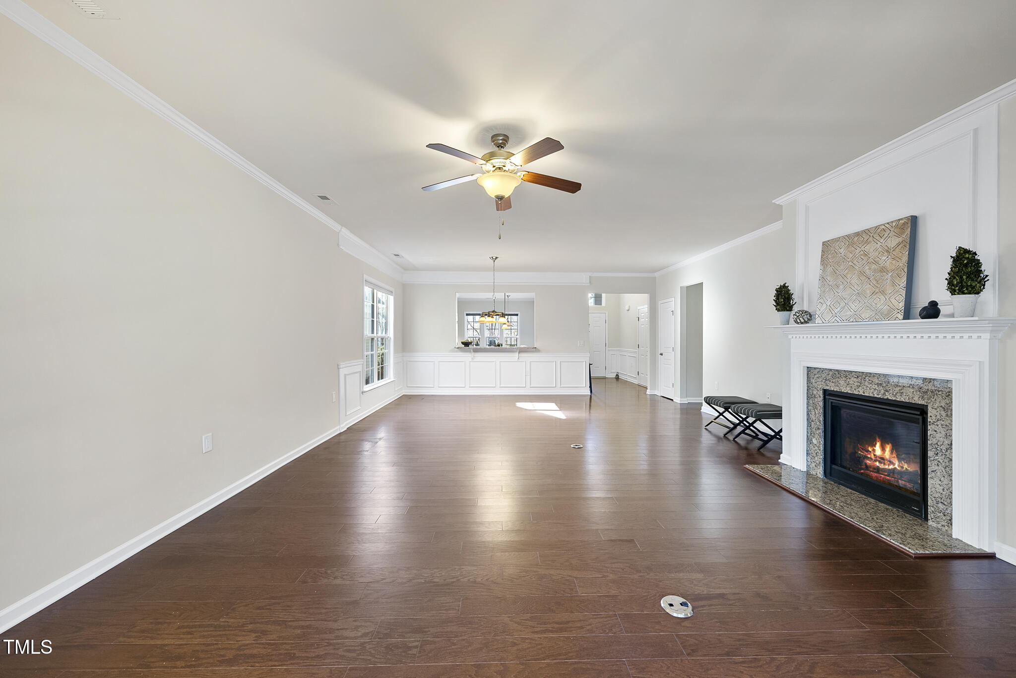 821 Blackfriars Loop Cary, NC 27519 - Photo 12 of 29 a view of livingroom with fireplace wooden floor and chandelier fan