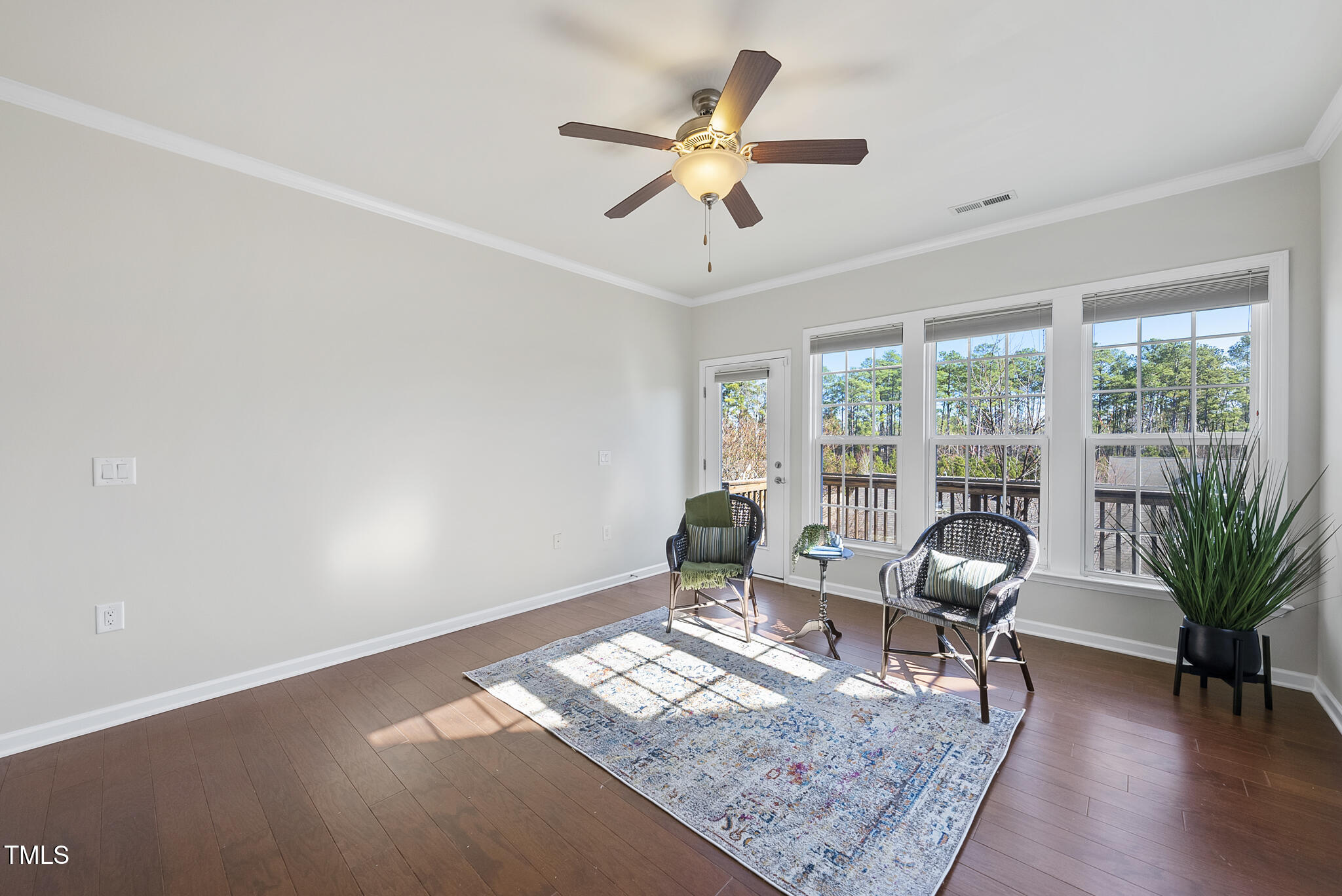 821 Blackfriars Loop Cary, NC 27519 - Photo 14 of 29 a living room with furniture and a large window with wooden floor