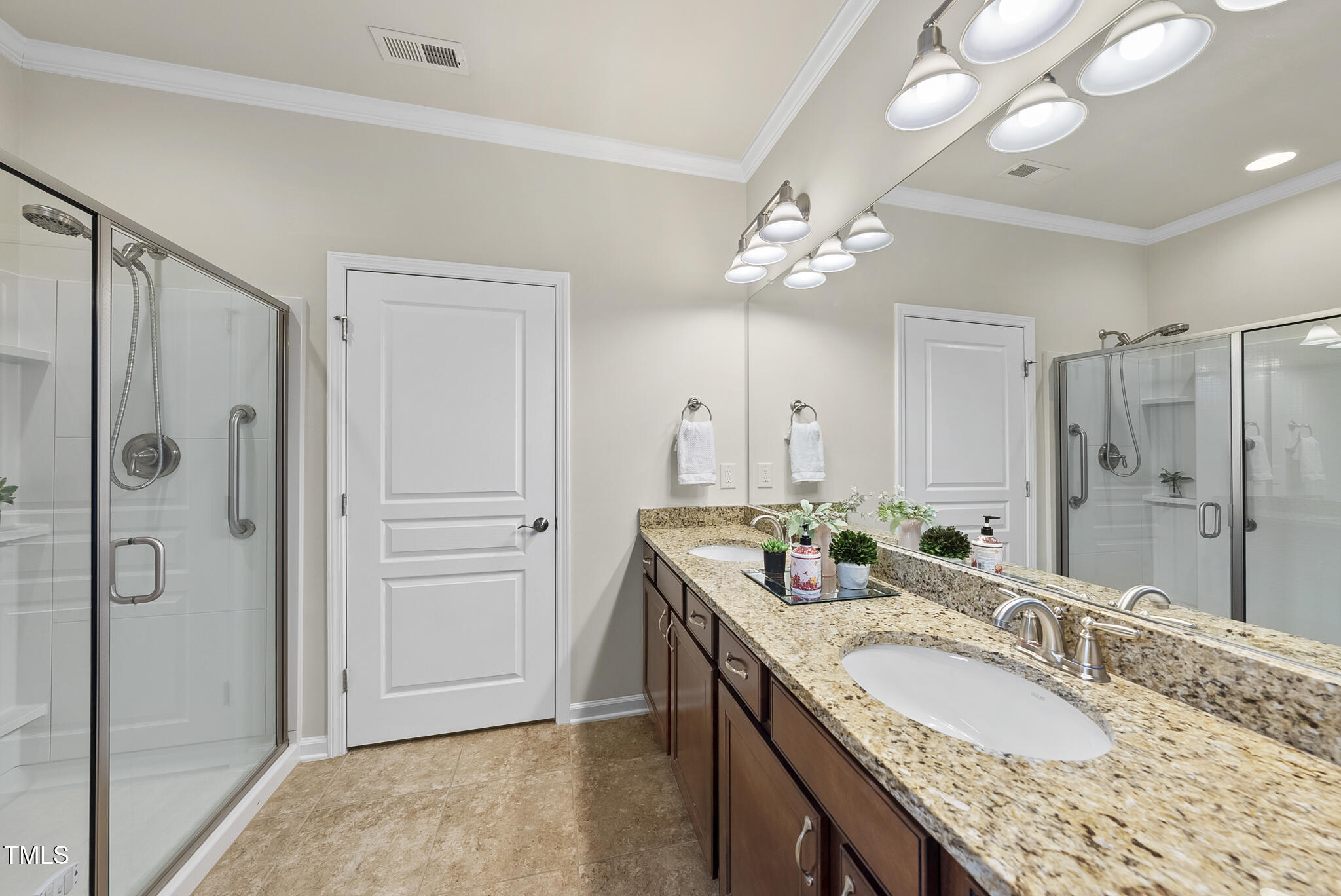 821 Blackfriars Loop Cary, NC 27519 - Photo 19 of 29 a bathroom with a granite countertop double vanity sink mirror and shower
