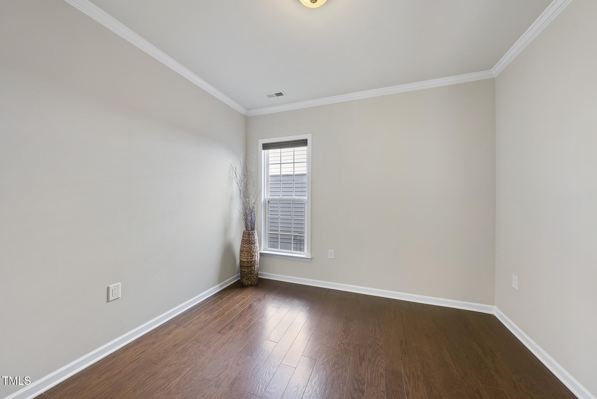 821 Blackfriars Loop Cary, NC 27519 - Photo 23 of 29 an empty room with wooden floor and windows