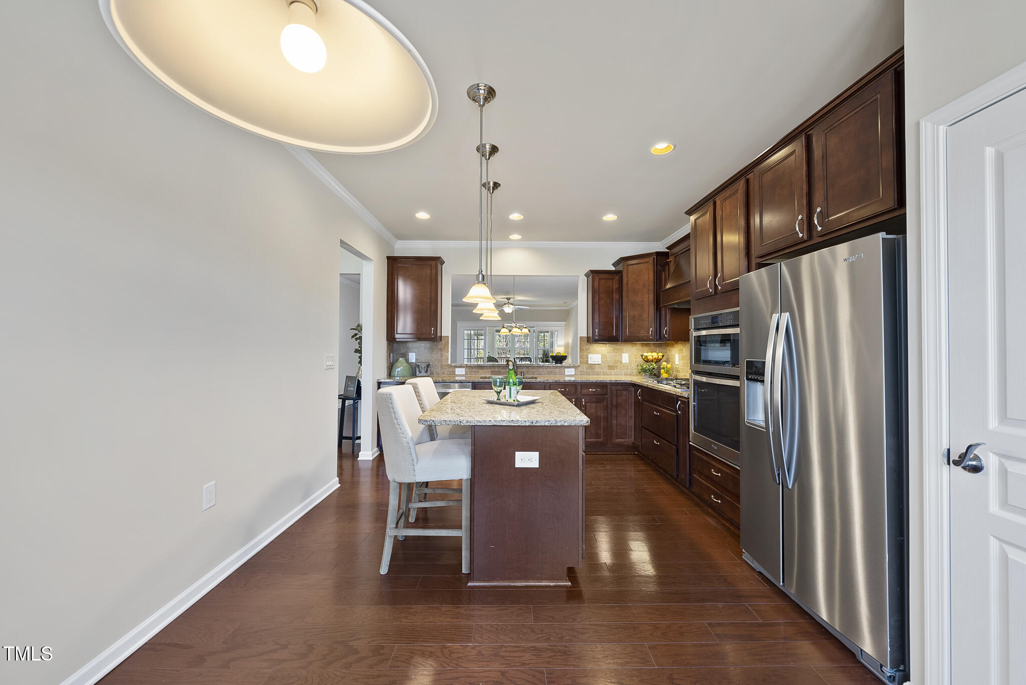 821 Blackfriars Loop Cary, NC 27519 - Photo 8 of 29 a kitchen with a refrigerator a sink dishwasher with a dining table and chairs