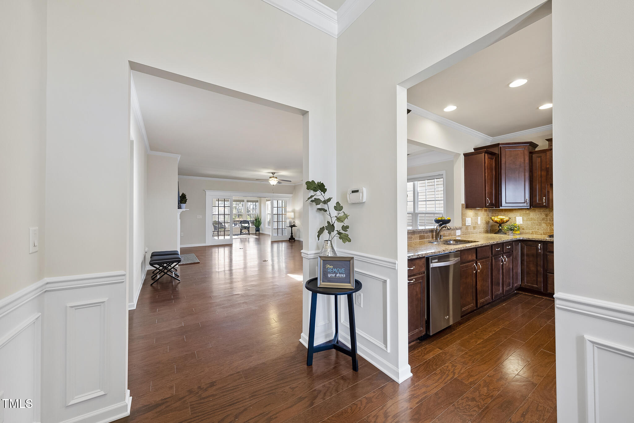 821 Blackfriars Loop Cary, NC 27519 - Photo 9 of 29 a kitchen with kitchen island granite countertop wooden floors and stainless steel appliances