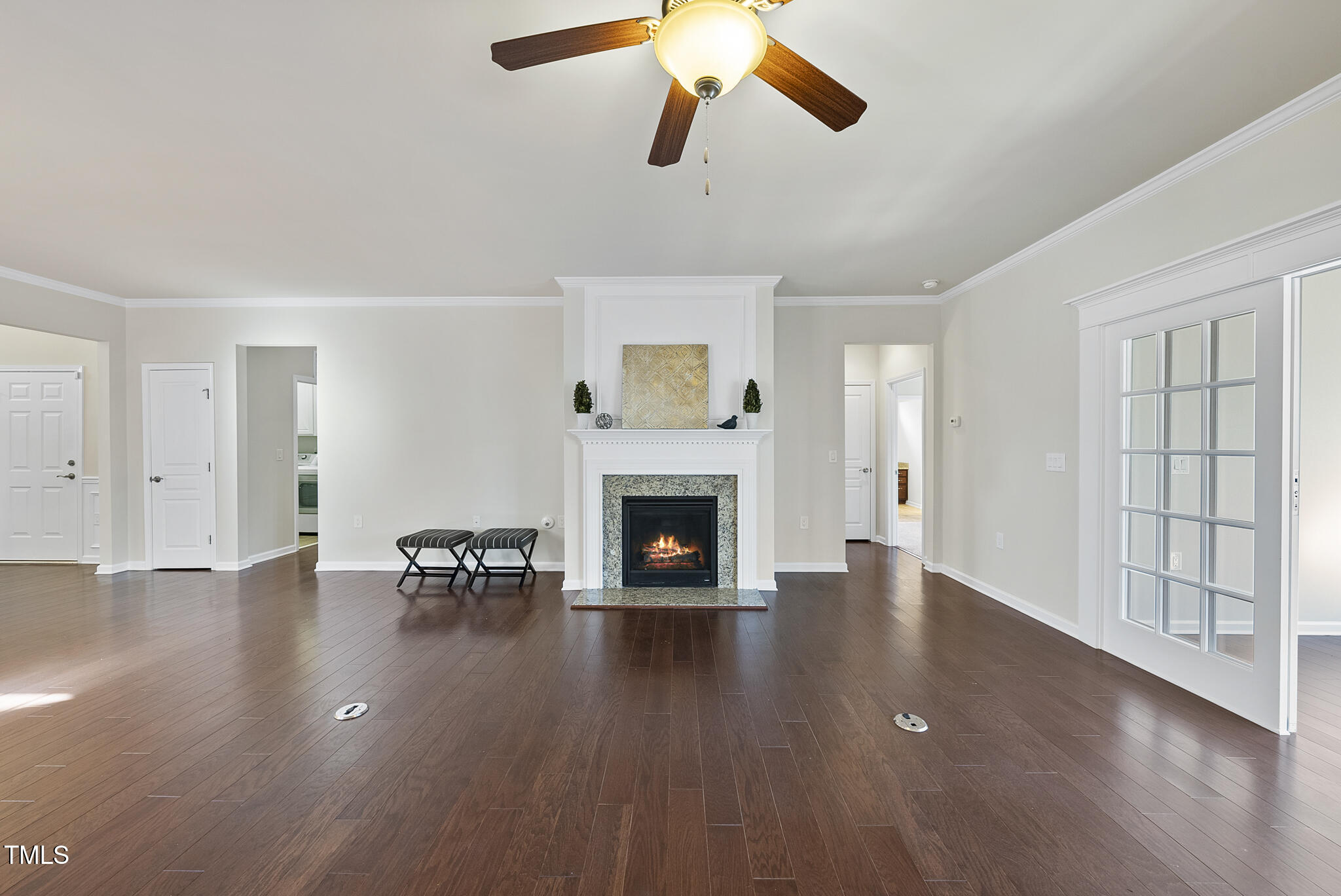 821 Blackfriars Loop Cary, NC 27519 - Photo 10 of 29 a view of an empty room with wooden floor fireplace and a window