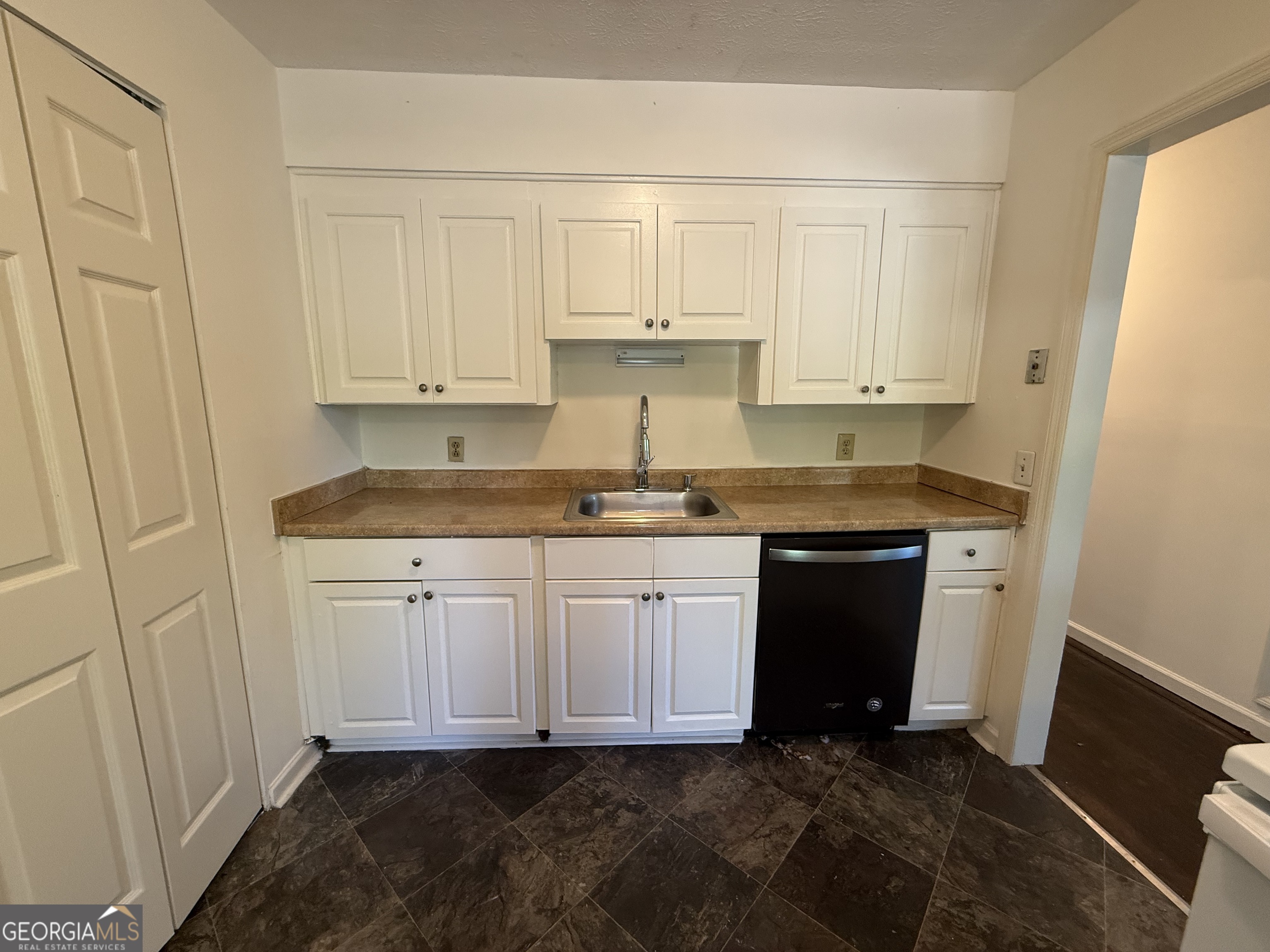 179 Youngs Mill Road LaGrange, GA 30241 - Photo 13 of 30 a kitchen with granite countertop white cabinets and white appliances