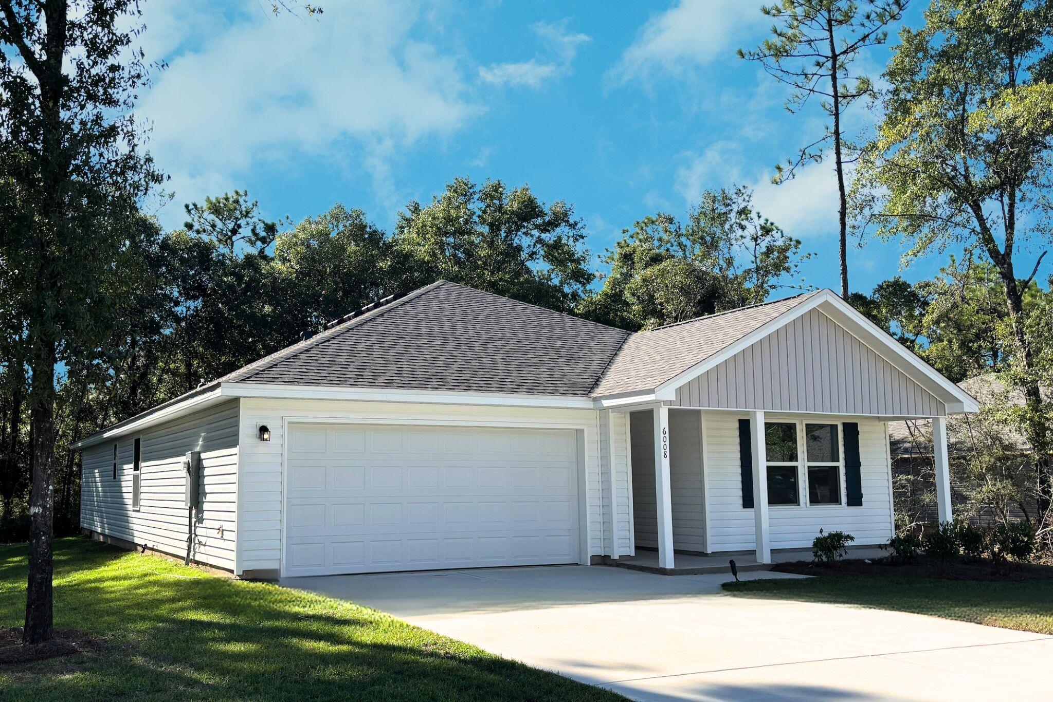 6008 Hidden Knoll Crestview, FL 32539 - Photo 2 of 28 a view of a white house with a yard plants and large tree