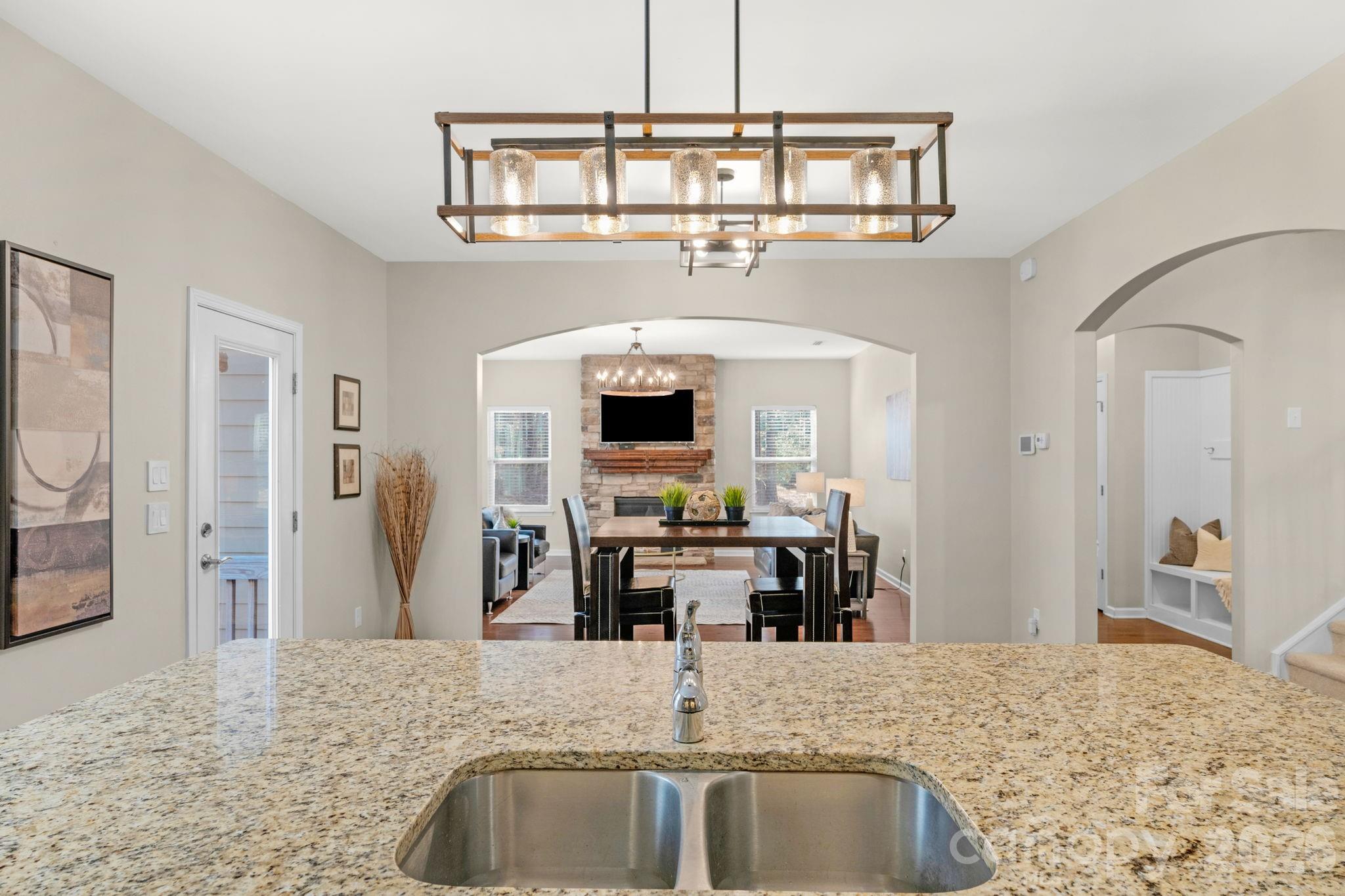 1508 Springfield Drive Waxhaw, NC 28173 - Photo 15 of 48 a view of a kitchen with kitchen island a sink and living area view