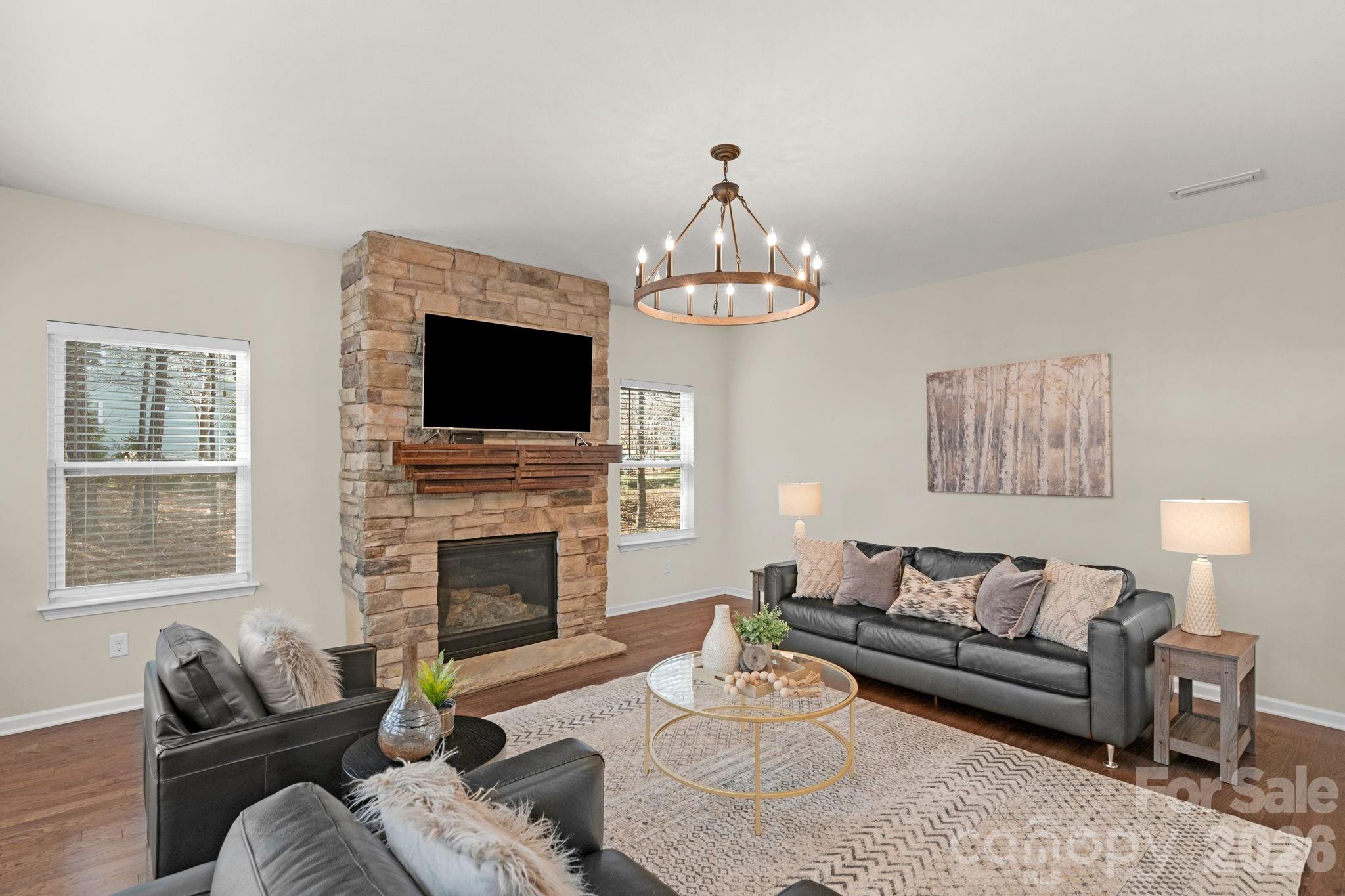 1508 Springfield Drive Waxhaw, NC 28173 - Photo 22 of 48 a living room with furniture a fireplace and a flat screen tv