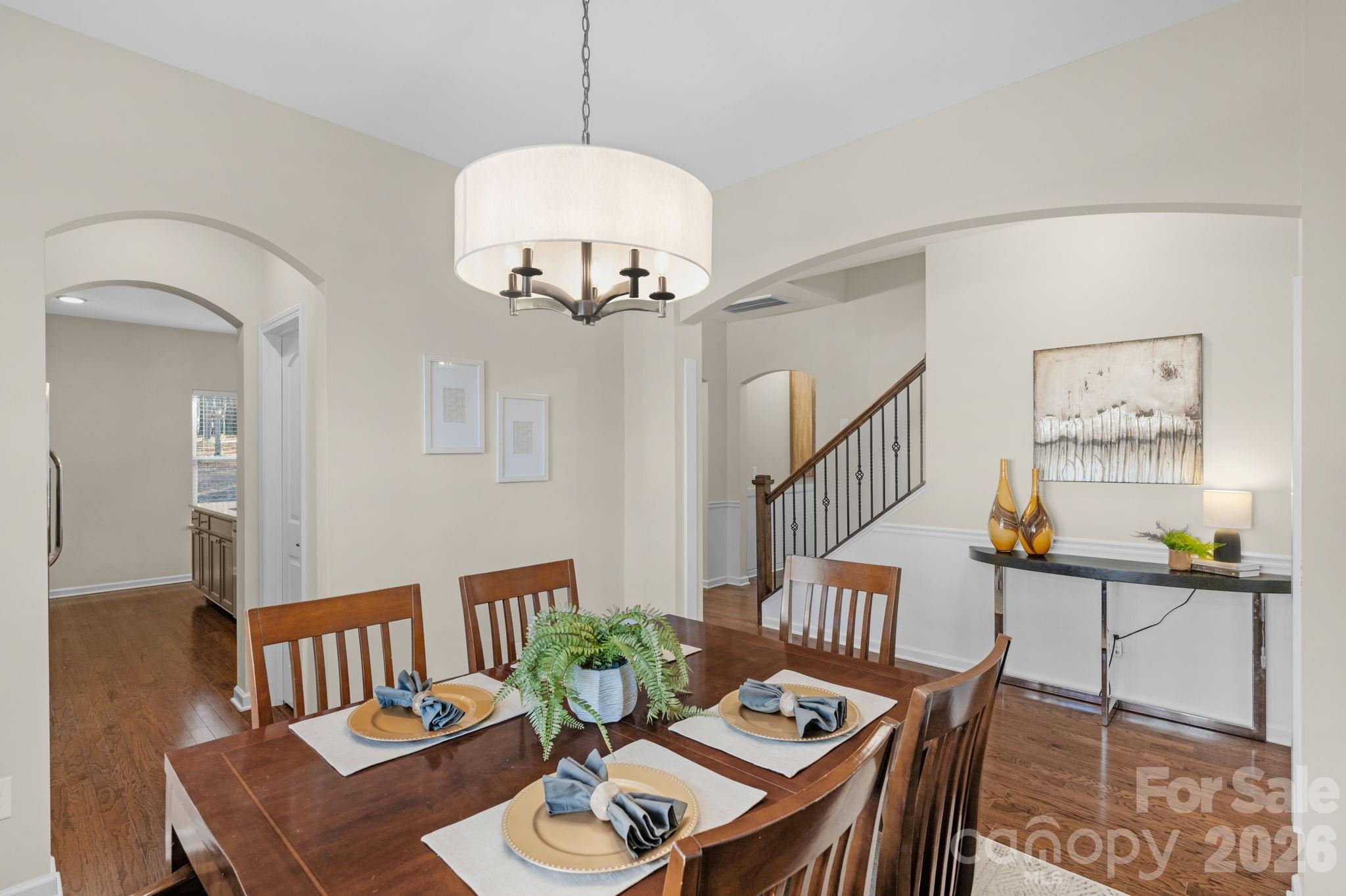 1508 Springfield Drive Waxhaw, NC 28173 - Photo 24 of 48 a view of a livingroom and dining room with furniture wooden floor and a chandelier