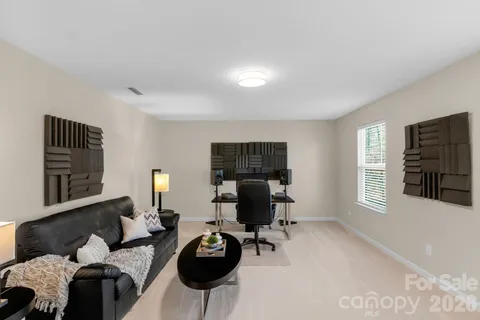 a living room with furniture windows and a flat screen tv