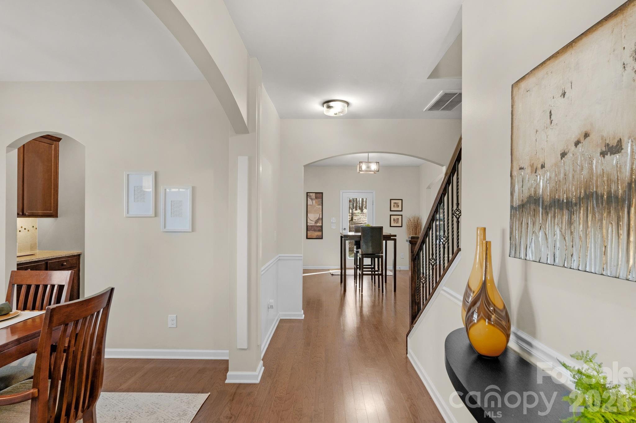 1508 Springfield Drive Waxhaw, NC 28173 - Photo 9 of 48 a hallway with wooden floor stairs and furniture