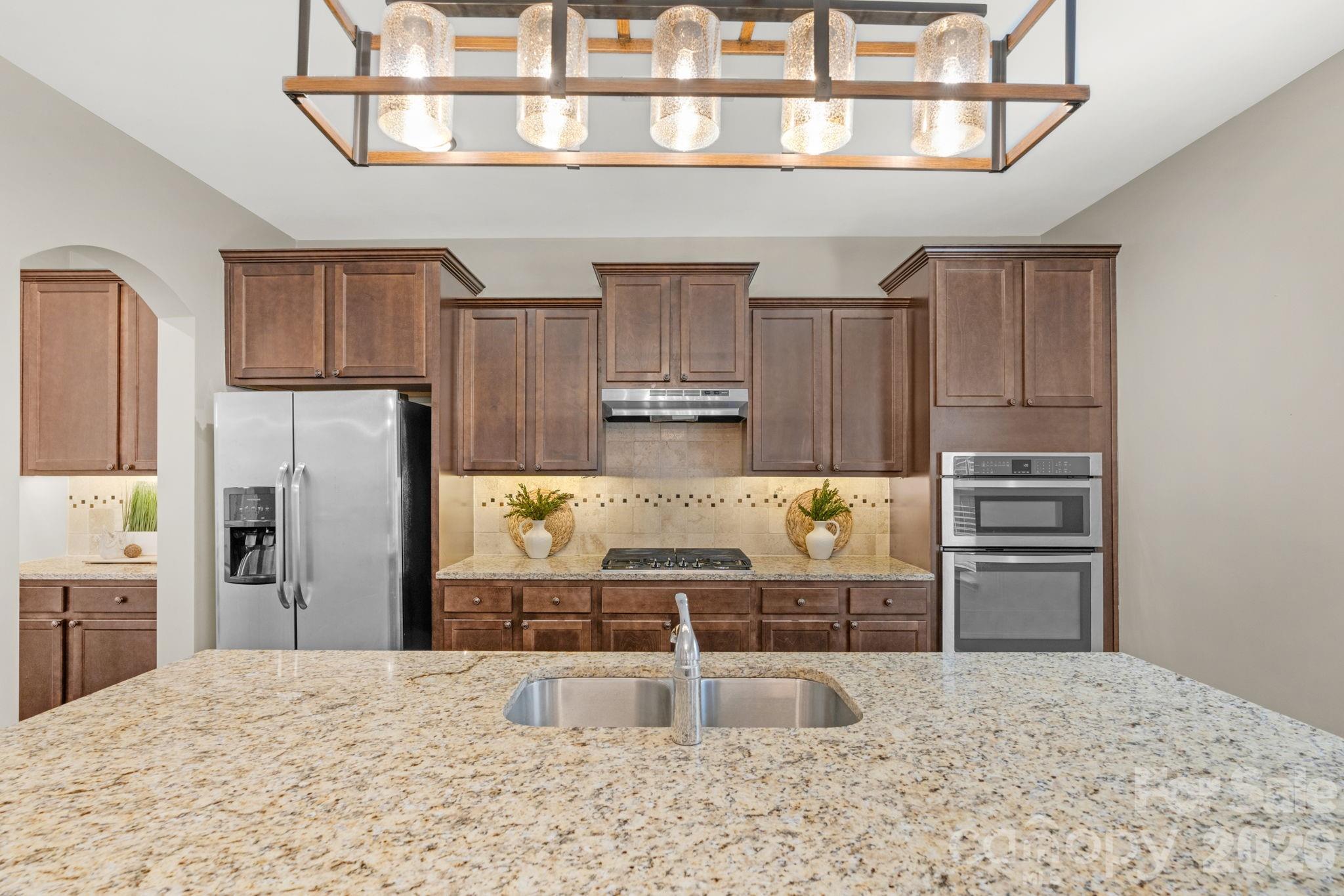 1508 Springfield Drive Waxhaw, NC 28173 - Photo 10 of 48 a kitchen with granite countertop a refrigerator and a sink