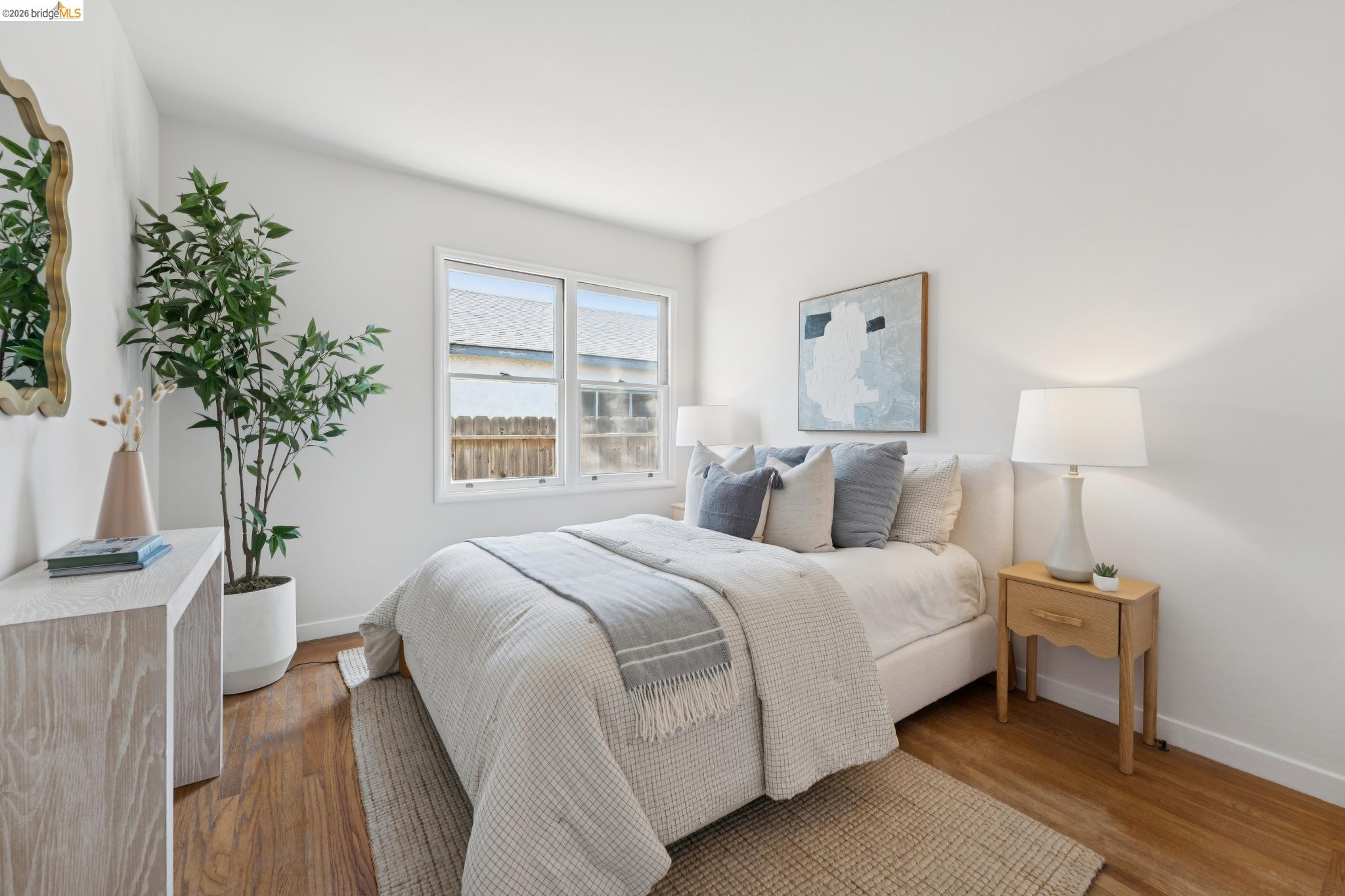 15162 Inverness Street San Leandro, CA 94579 - Photo 11 of 25 Bright bedroom featuring wood-finish flooring, crisp white walls, and a large window providing natural light