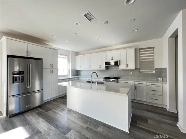 a kitchen with refrigerator cabinets and stainless steel appliances