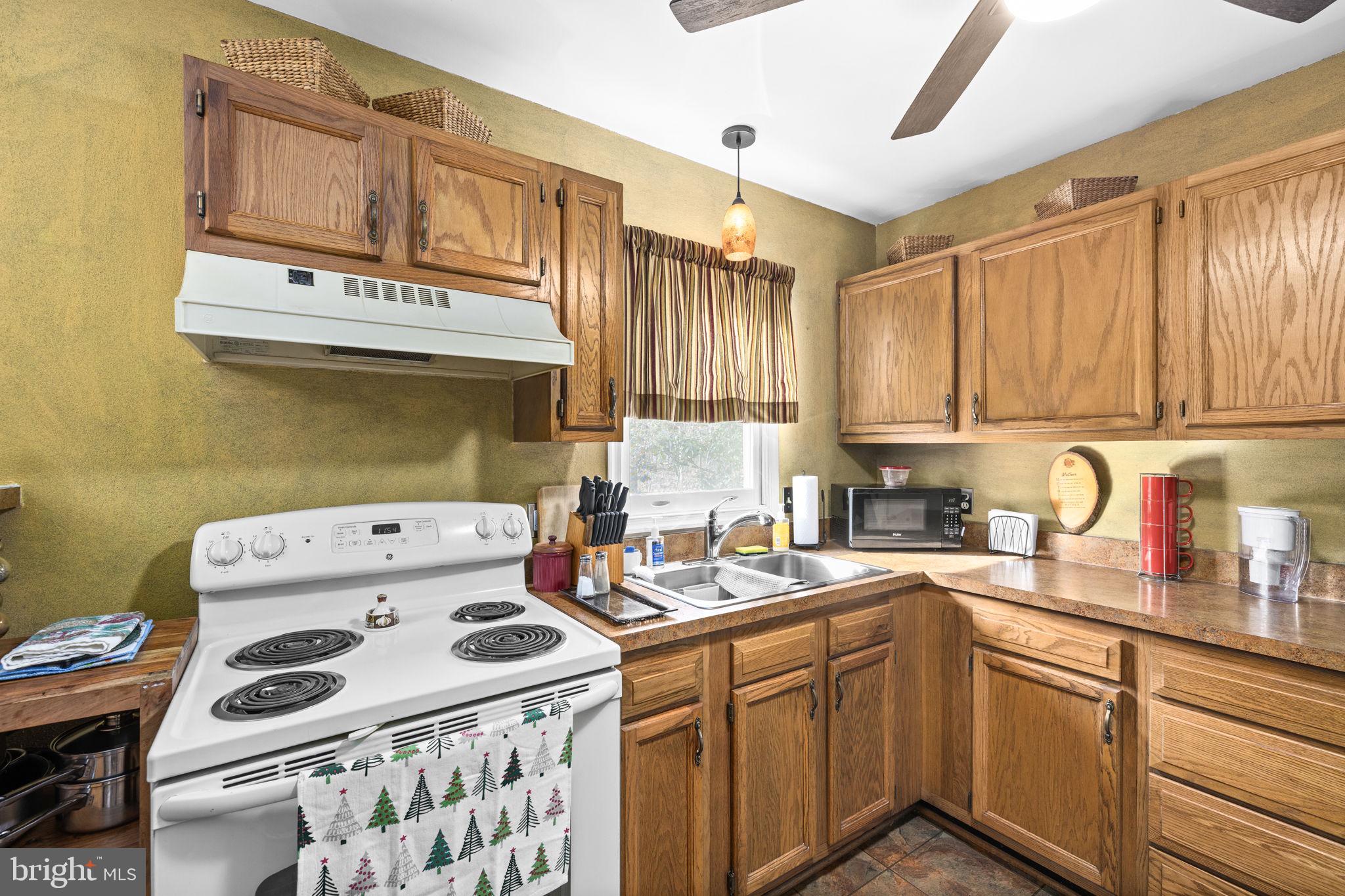 227 Cedar Ridge Drive Ruther Glen, VA 22546 - Photo 12 of 44 a kitchen with a sink a stove and cabinets