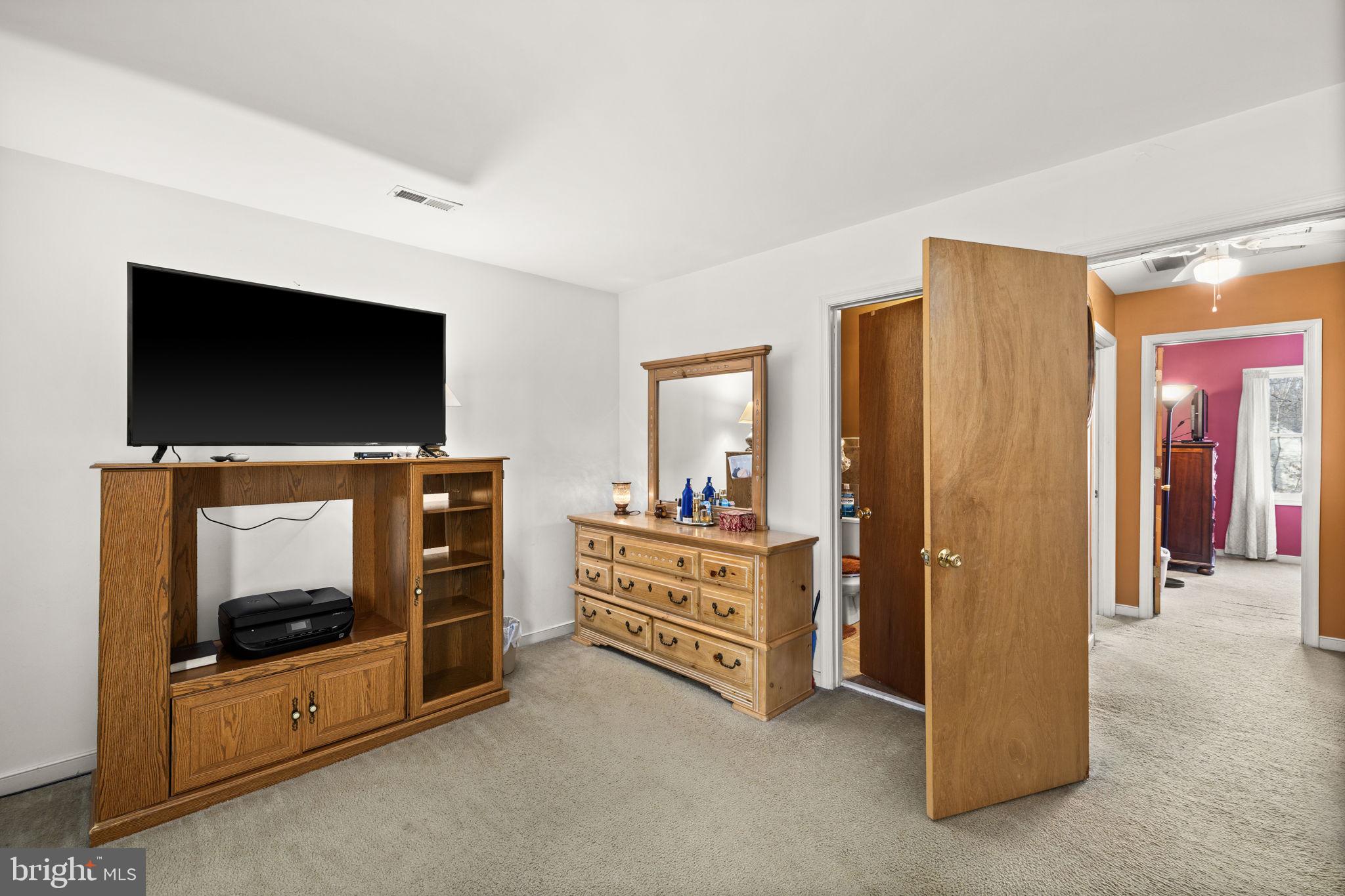 227 Cedar Ridge Drive Ruther Glen, VA 22546 - Photo 17 of 44 a view of an empty room with a fireplace and a flat screen tv